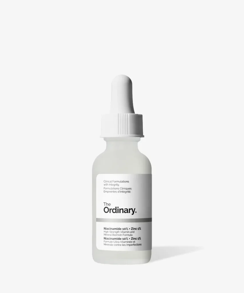 A bottle of The Ordinary Niacinamide 10% + Zinc 1% serum with a white dropper cap, labeled as a high-strength vitamin and mineral blemish formula.