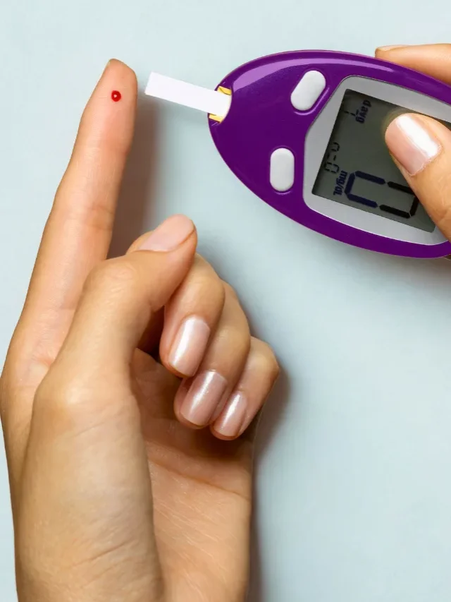 An image of a lady hand with glucometer and measruing blood sugar level