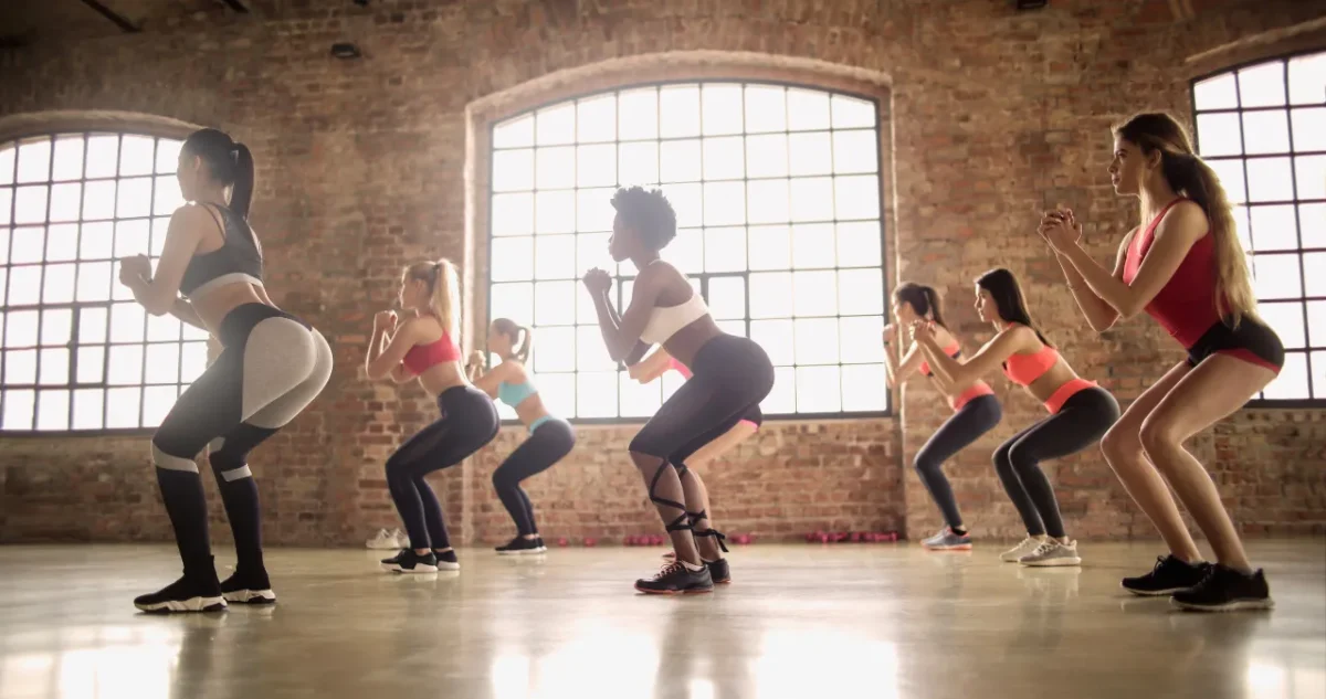 an image of a group of lady doing squat jumps exercise for weight loss
